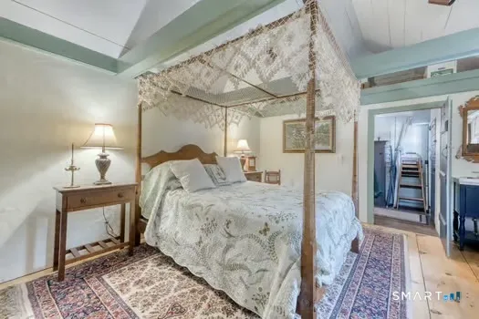 a bed room with a bed and a mirror