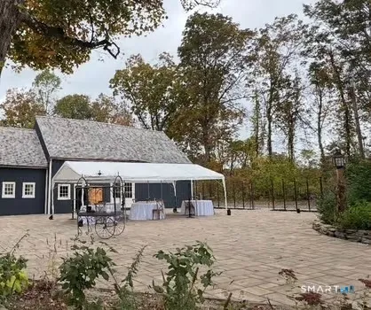 a view of a house with backyard and sitting area
