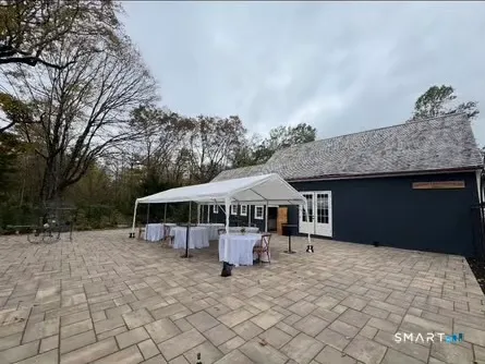 a view of a house with backyard and sitting area