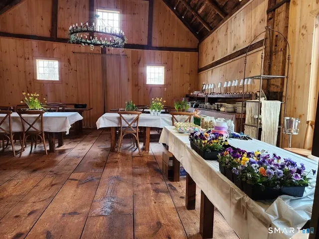 a outdoor dining space with lots of potted plants