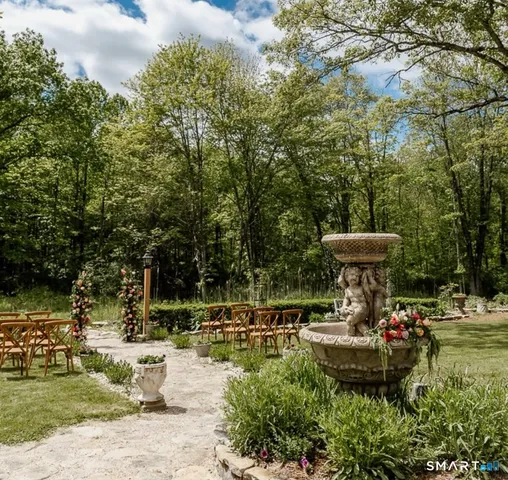 a view of a lake with a bench and trees around
