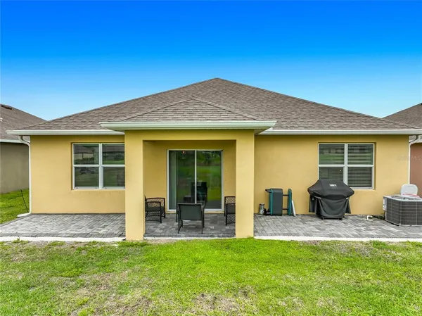 a front view of a house with a garden and patio