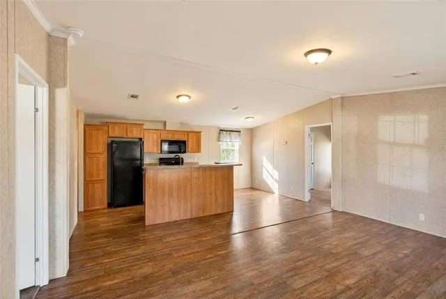 a view of a kitchen with a sink and a refrigerator