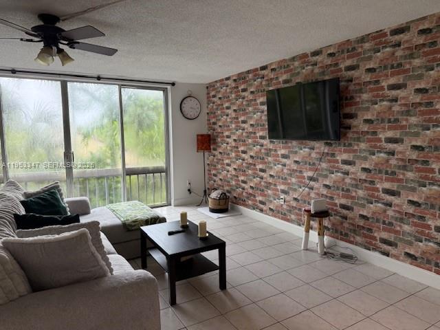 8401 West Sample Road, Unit 14 Coral Springs, FL 33065 - Photo 1 of 32 a living room with furniture and a flat screen tv