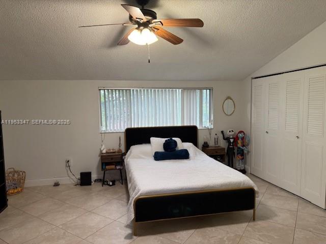 8401 West Sample Road, Unit 14 Coral Springs, FL 33065 - Photo 13 of 32 a bedroom with a bed and a chandelier