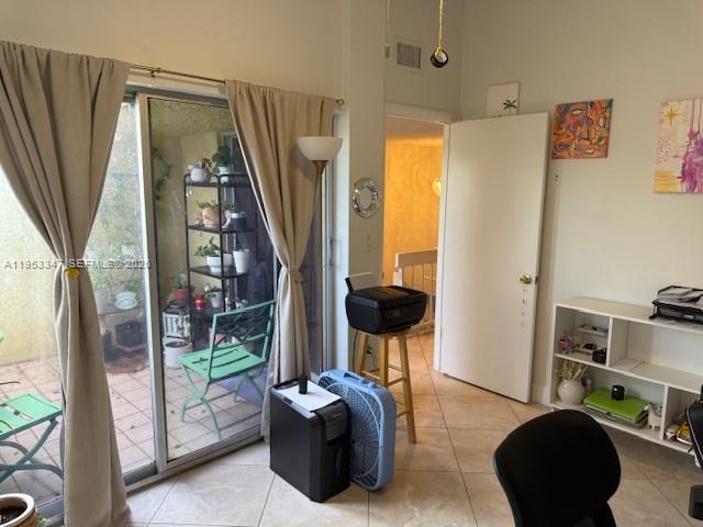 8401 West Sample Road, Unit 14 Coral Springs, FL 33065 - Photo 19 of 32 a living room with furniture a floor to ceiling window and potted plant