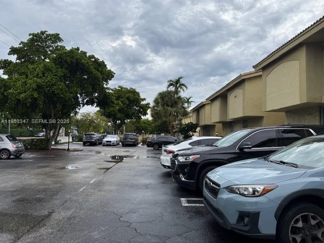 8401 West Sample Road, Unit 14 Coral Springs, FL 33065 - Photo 27 of 32 a car parked in front of a house