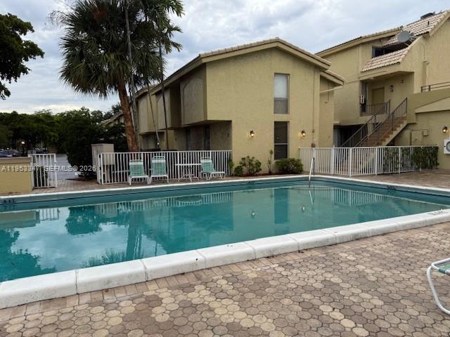 8401 West Sample Road, Unit 14 Coral Springs, FL 33065 - Photo 32 of 32 a view of swimming pool with a yard