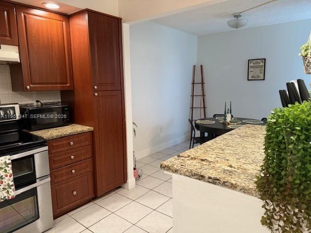 8401 West Sample Road, Unit 14 Coral Springs, FL 33065 - Photo 6 of 32 a kitchen with a refrigerator and a stove
