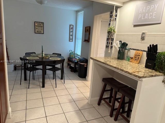 8401 West Sample Road, Unit 14 Coral Springs, FL 33065 - Photo 7 of 32 a living room with a table and chairs in it