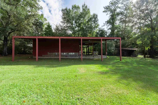 an empty room with a window and a ceiling fan