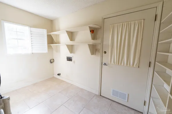 a large kitchen with stainless steel appliances a large window