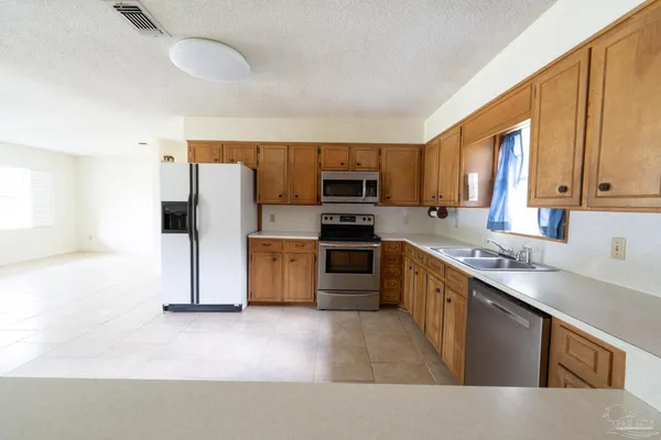 an empty room with a ceiling fan and a window