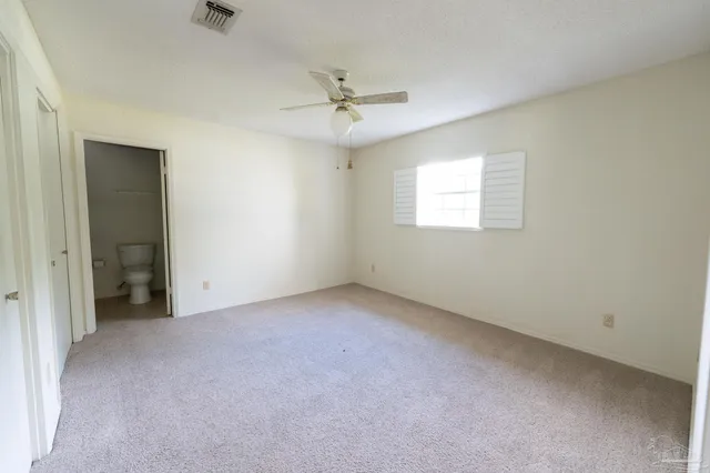a view of a kitchen with furniture and stainless steel appliances