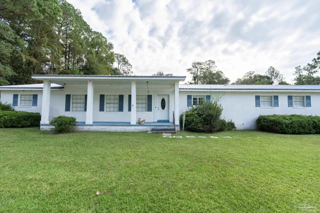 a view of a house with a backyard