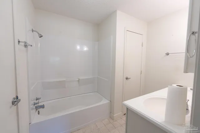 a bathroom with a sink mirror vanity and toilet