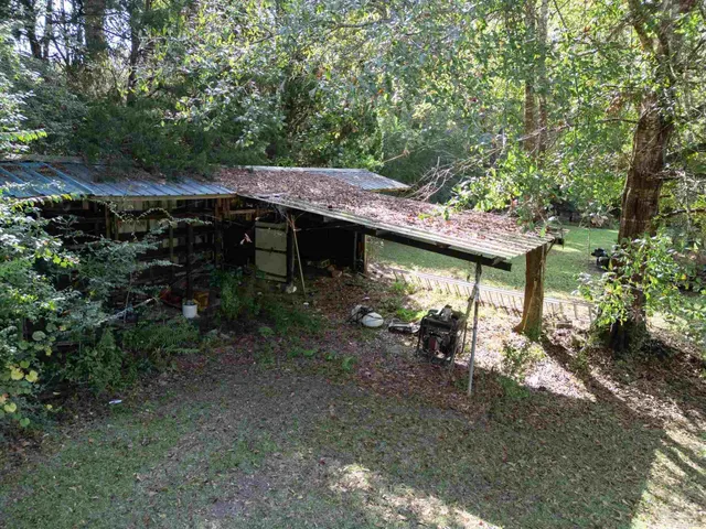 a view of a chairs and table in patio