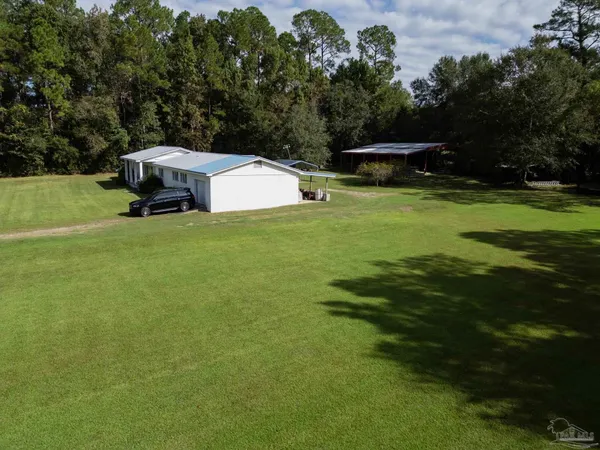 a view of a small house with a park