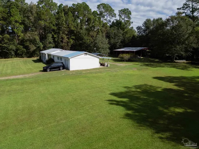 a view of a small house with a park