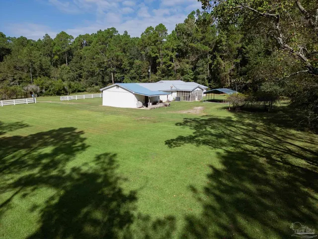 a view of a house with a yard and sitting area