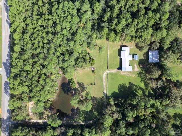 an aerial view of a house with a yard