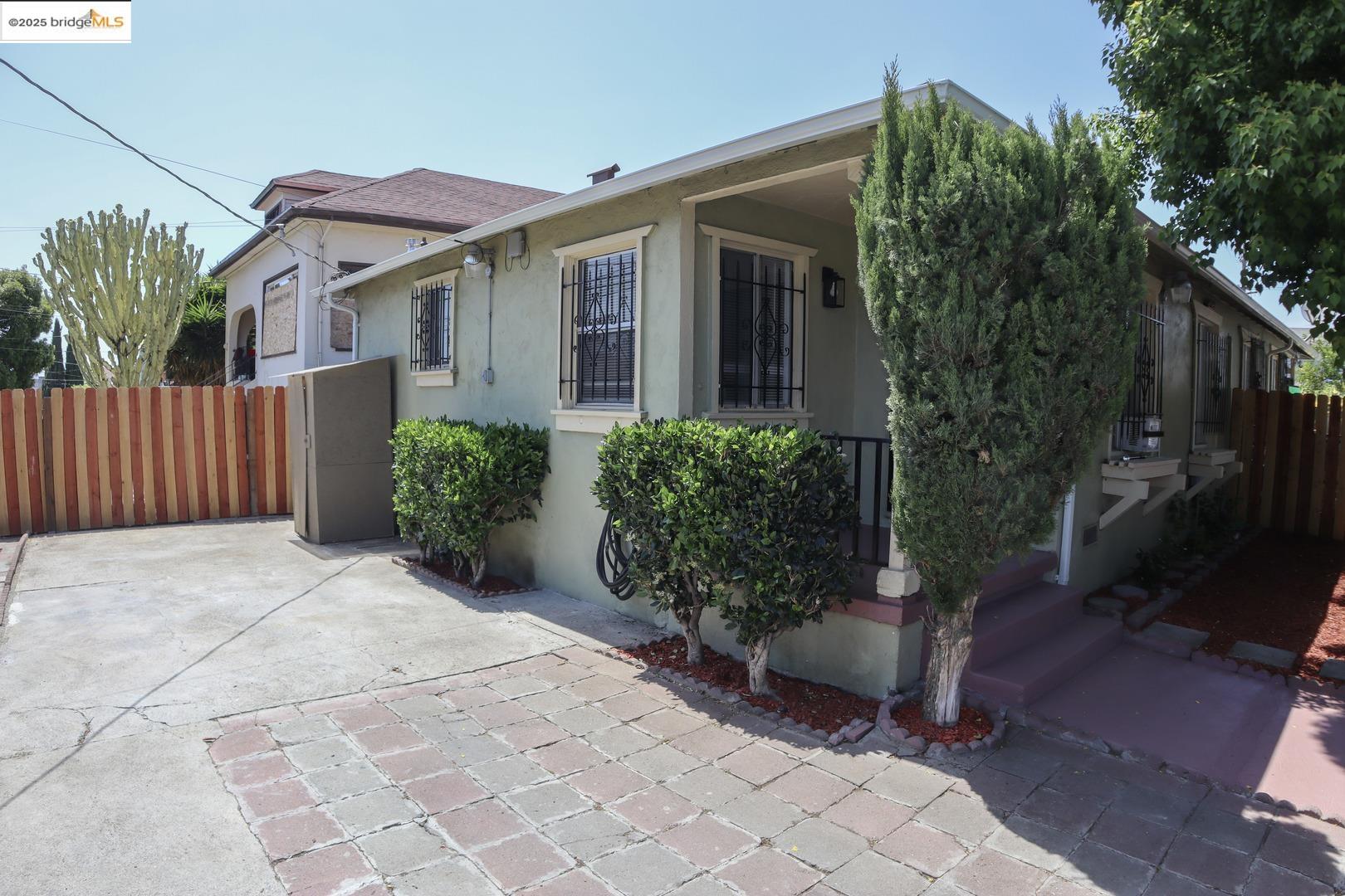 a view of a patio with plants and wooden fence