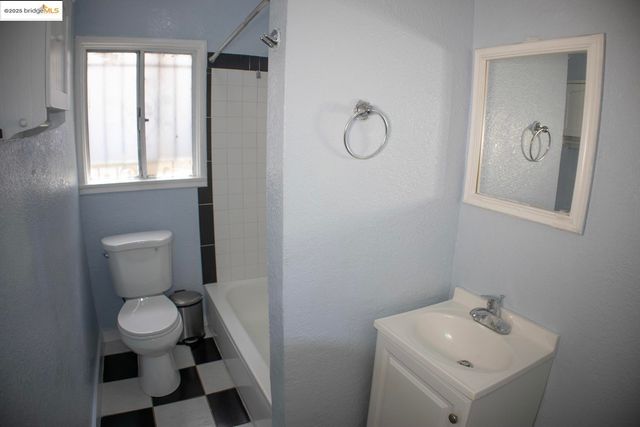 a bathroom with a sink toilet and a mirror