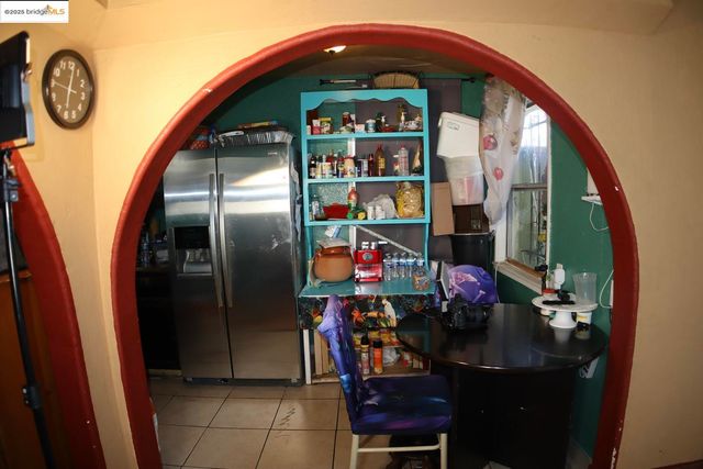 a kitchen with stainless steel appliances granite countertop a refrigerator a stove a microwave and a dining table with wooden floor