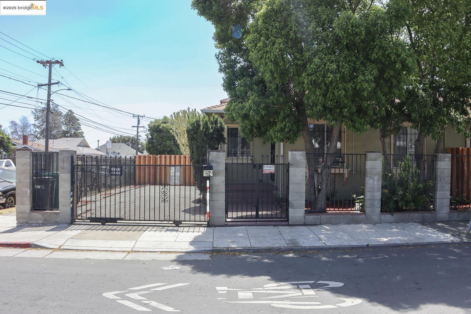 6921 Flora Street Oakland, CA 94621 - Photo 3 of 22 a view of a house with a iron gate