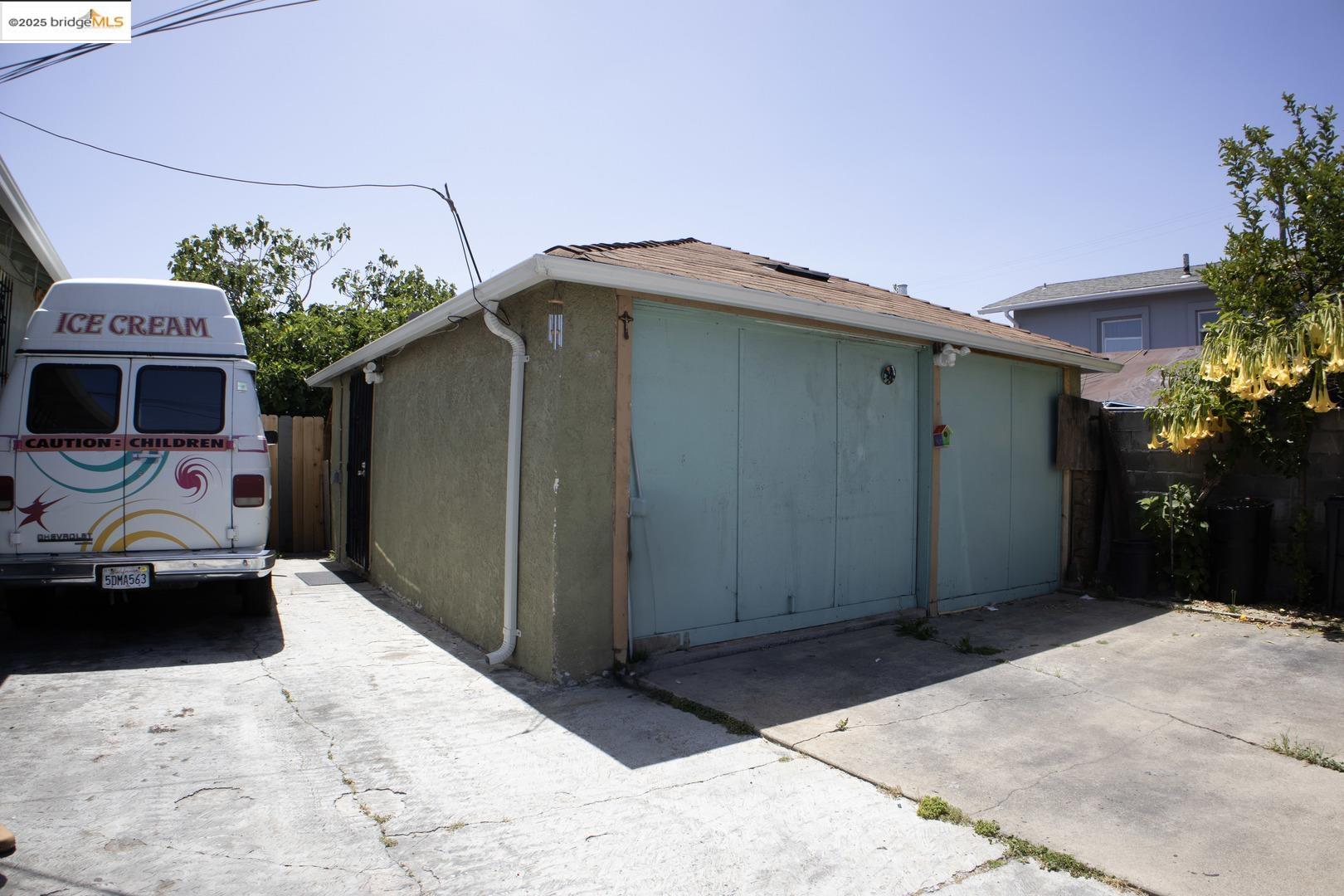 6921 Flora Street Oakland, CA 94621 - Photo 6 of 22 a front view of a house with garage