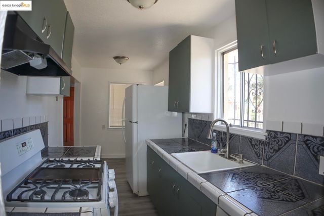 a kitchen with a sink stove and refrigerator