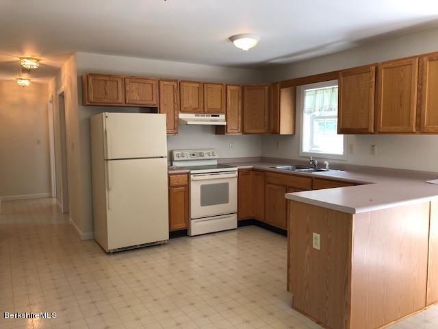 525 W Road Clarksburg, MA 01247 - Photo 2 of 23 a kitchen with a refrigerator a stove a sink and cabinets