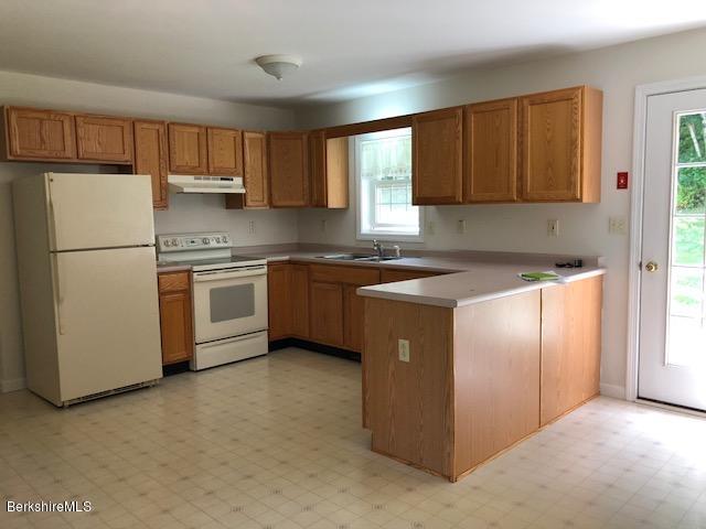 525 W Road Clarksburg, MA 01247 - Photo 3 of 23 a kitchen with stainless steel appliances granite countertop a refrigerator a sink a stove and white cabinets