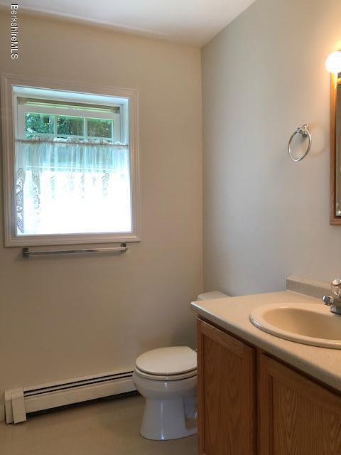525 W Road Clarksburg, MA 01247 - Photo 9 of 23 a bathroom with a sink a toilet and a window