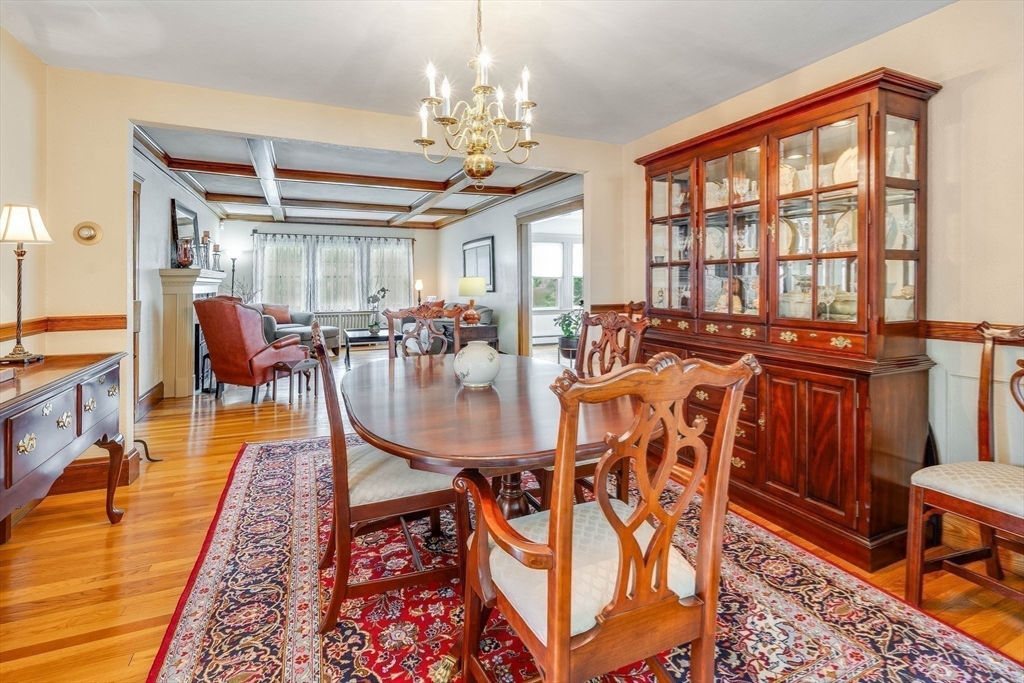 223 Lawrence Road Medford, MA 02155 - Photo 12 of 40 a view of a dining room with furniture a chandelier and wooden floor