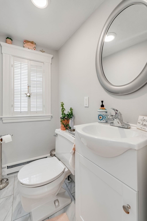 223 Lawrence Road Medford, MA 02155 - Photo 14 of 40 a bathroom with a sink mirror and toilet