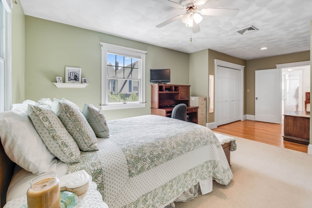 223 Lawrence Road Medford, MA 02155 - Photo 17 of 40 a bedroom with a bed and a chandelier