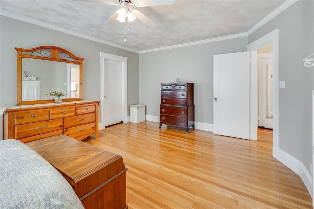 223 Lawrence Road Medford, MA 02155 - Photo 20 of 40 a bedroom with a bed and wooden floor