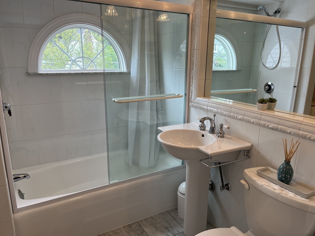 223 Lawrence Road Medford, MA 02155 - Photo 23 of 40 a bathroom with a sink toilet and a mirror
