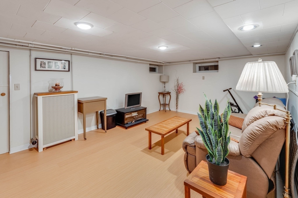 223 Lawrence Road Medford, MA 02155 - Photo 26 of 40 a living room with furniture and a flat screen tv