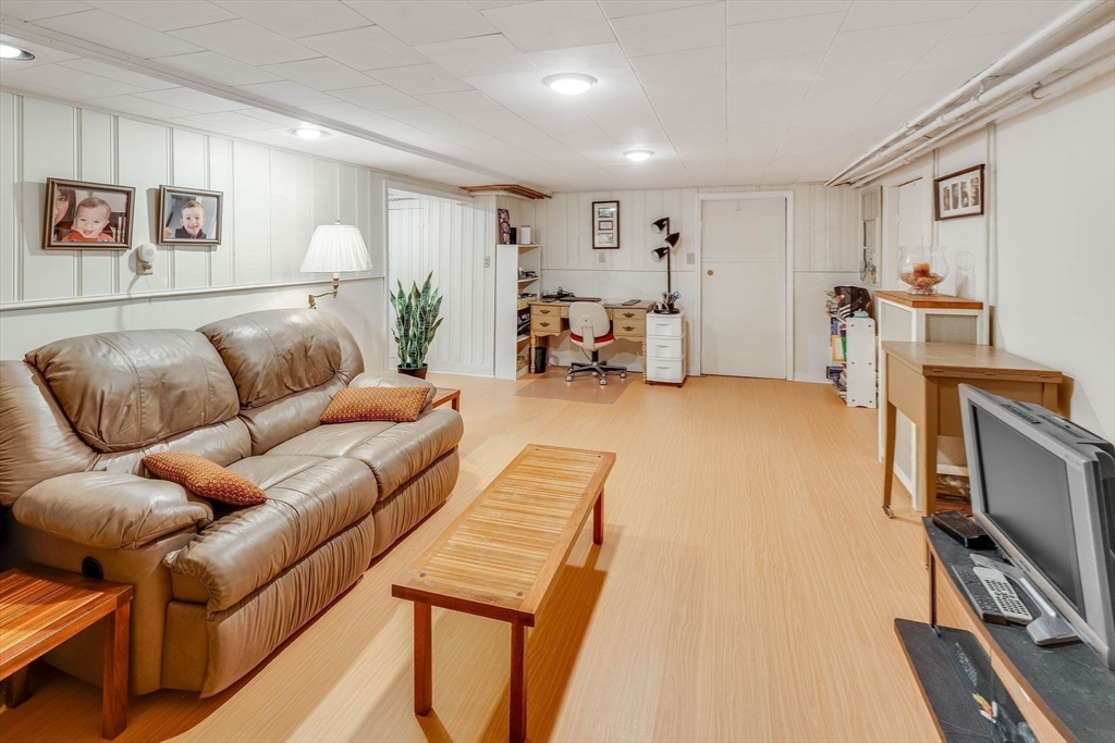 223 Lawrence Road Medford, MA 02155 - Photo 27 of 40 a living room with furniture and a flat screen tv