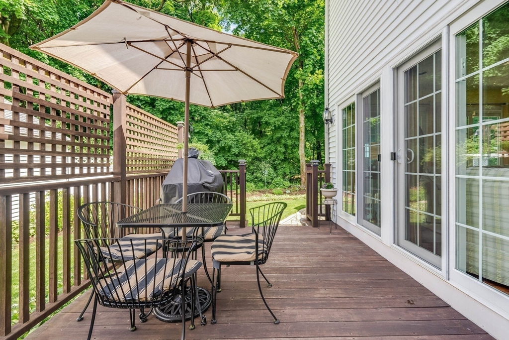223 Lawrence Road Medford, MA 02155 - Photo 29 of 40 a view of a patio with a table and chairs under an umbrella