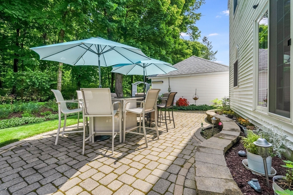 223 Lawrence Road Medford, MA 02155 - Photo 31 of 40 a view of a patio with table and chairs under an umbrella