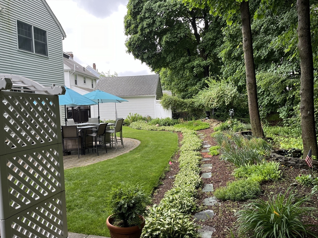223 Lawrence Road Medford, MA 02155 - Photo 33 of 40 a view of a backyard with table and chairs and potted plants
