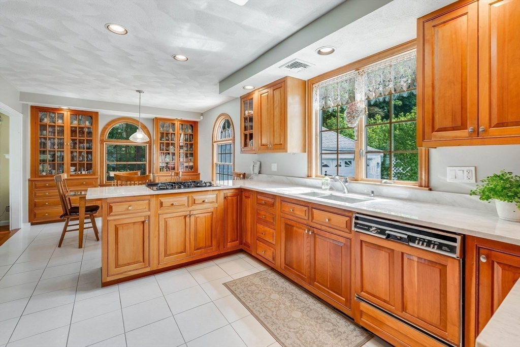 223 Lawrence Road Medford, MA 02155 - Photo 4 of 40 a large kitchen with stainless steel appliances granite countertop a stove a sink and a microwave