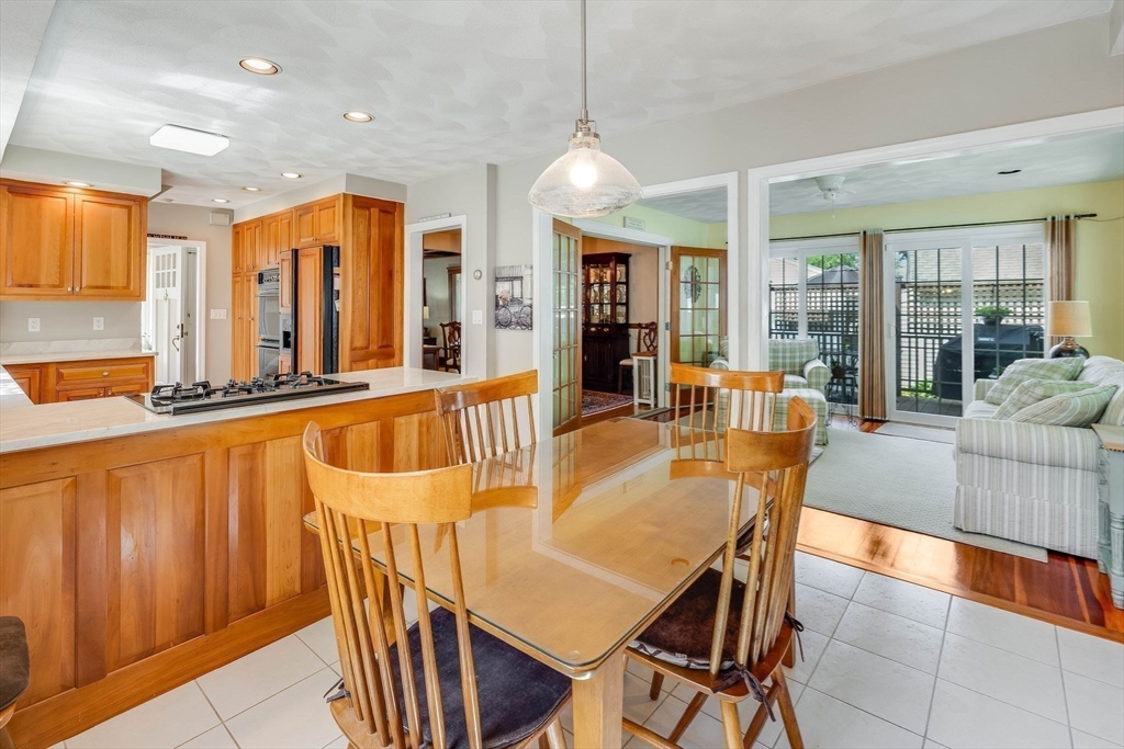 223 Lawrence Road Medford, MA 02155 - Photo 7 of 40 a dining room with furniture a chandelier and wooden floor
