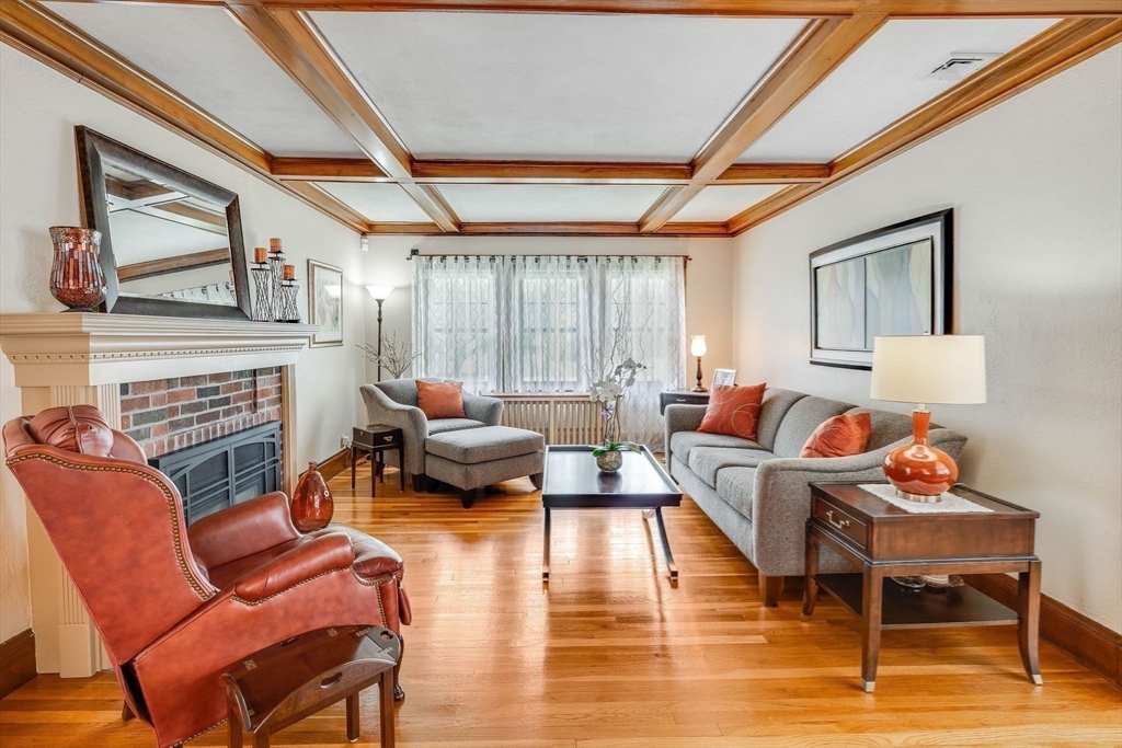 223 Lawrence Road Medford, MA 02155 - Photo 10 of 40 a living room with furniture a fireplace and a large window