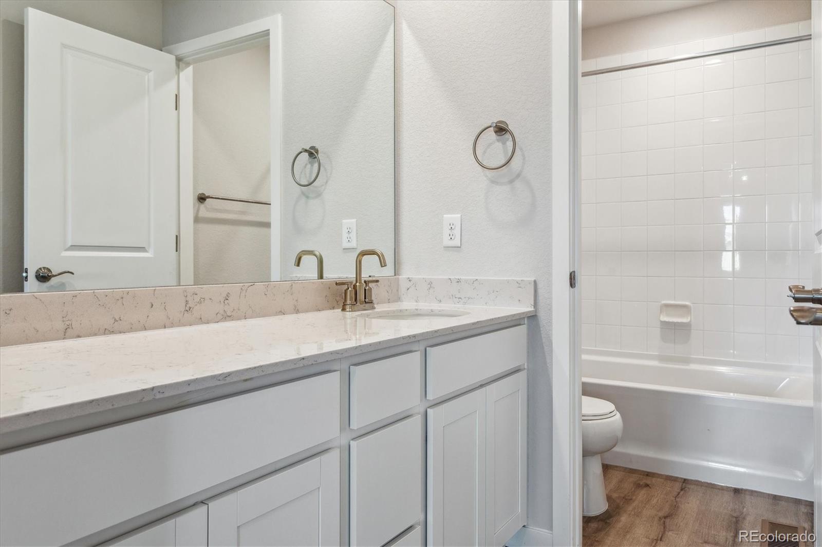 4255 Gozzer Ranch Drive Elizabeth, CO 80107 - Photo 11 of 21 a bathroom with a shower sink and mirror