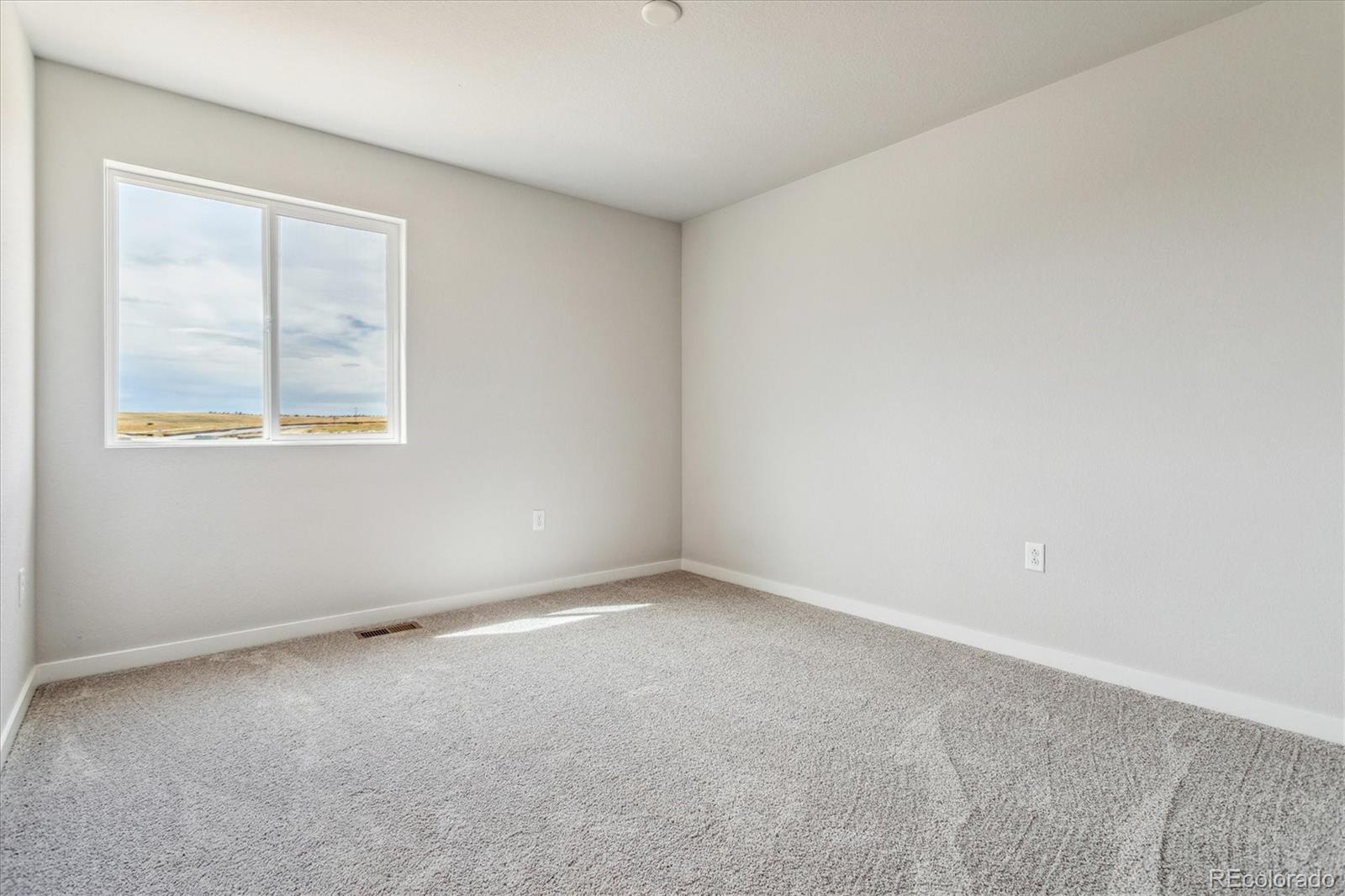 4255 Gozzer Ranch Drive Elizabeth, CO 80107 - Photo 12 of 21 an empty room with a window