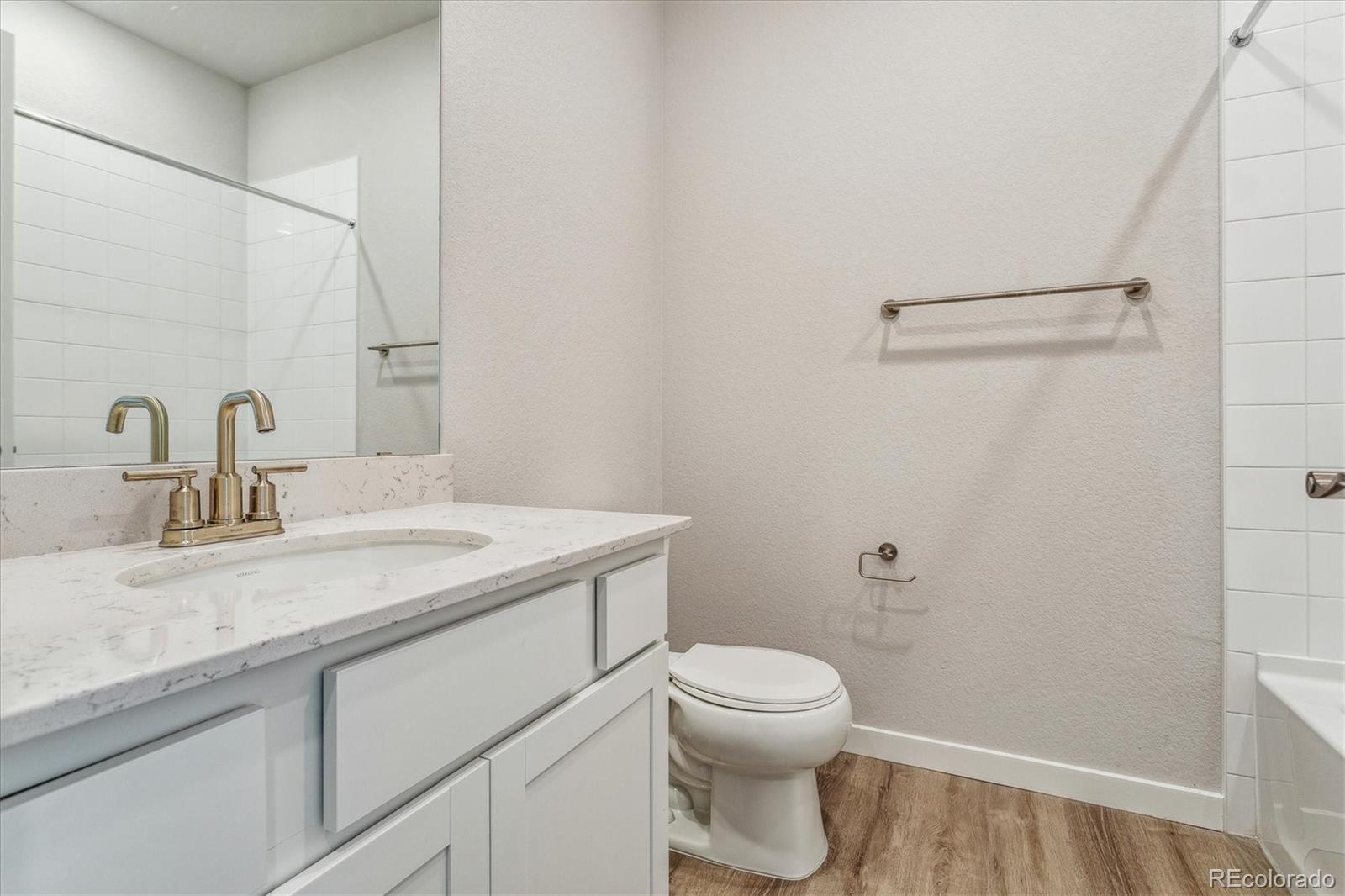 4255 Gozzer Ranch Drive Elizabeth, CO 80107 - Photo 8 of 21 a bathroom with a granite countertop sink toilet and a mirror